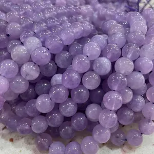 Close-up macro view of natural lavender amethyst round loose beads for DIY jewelry