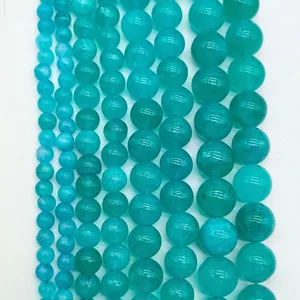 Detailed view showing different sizes of round cyan gemstone beads in a vertical layout