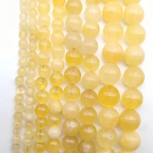 Close-up of translucent yellow round quartz beads for jewelry making