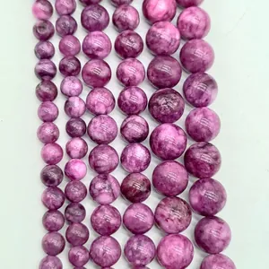 Close-up of lavender amethyst round loose beads with natural swirled texture patterns
