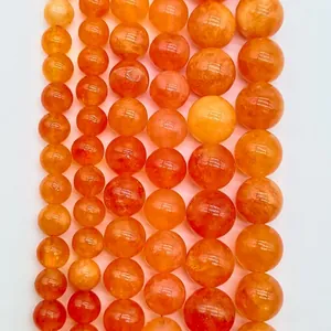 Detailed macro view of translucent orange round natural stone beads for jewelry making