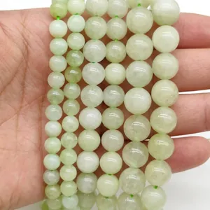 Detailed view of pale green round stone beads in various sizes for DIY jewelry making