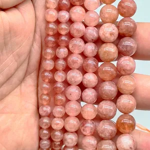 Macro close-up detail of natural pink strawberry quartz translucent round loose beads