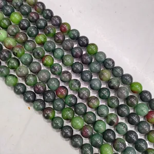 High-quality close-up of green and red ruby zoisite round stone beads for jewelry making