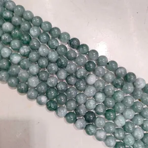 Close-up of green natural stone beads showing polished texture and luster