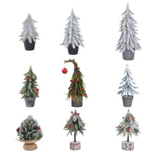 Assorted mini artificial Christmas trees with flocked snow and red berry desktop decorations