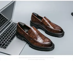 Close-up van stijlvolle bruine leren loafers met krokodillenprint en een dikke rubberen zool