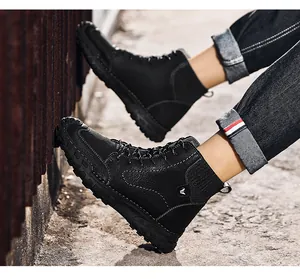 Close-up of black high-top casual men's boots with textured leather and thick lug sole