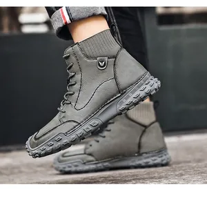 Close-up detail of gray high-top men's casual boots with a rugged textured rubber sole