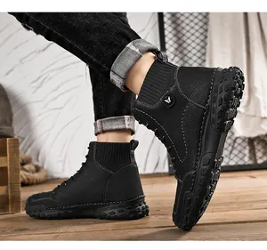 Close-up of black high-top men's casual boots with textured leather and thick lug sole