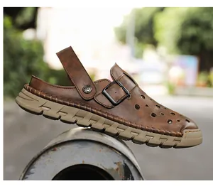 Close-up of men's brown breathable leather clogs with buckle detail and lug sole.