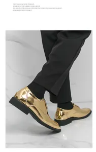 Detailed view of shiny metallic gold monk strap shoes for men on white marble background