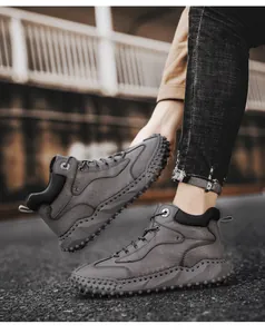 Detailed view of grey handmade leather outdoor hiking boots with textured non-slip sole.