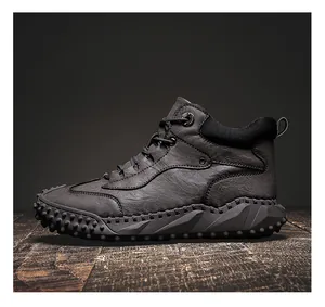 Detail view of durable high-top men's outdoor leather boots with rugged textured rubber sole