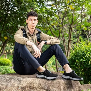 Men's waterproof outdoor hiking shoes styled with casual wear in a nature setting