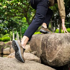 Professional men's non-slip outdoor hiking sports shoes shown climbing rocky terrain