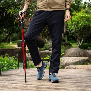 Close-up of blue outdoor hiking shoes with non-slip thick soles on a wooden bridge
