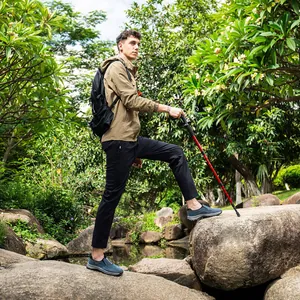 Professional men's waterproof hiking shoes shown in a rugged outdoor trekking scenario