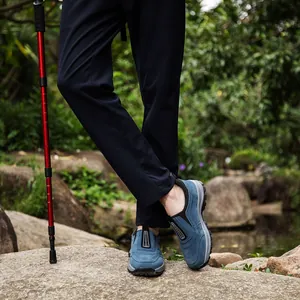 Men's waterproof outdoor shoes with anti-slip thick sole shown in a hiking scene.