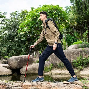 Action shot showing the slip-on design and rugged sole of the men's trekking shoes.