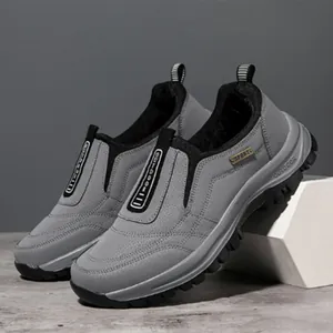 Macro view of grey men's outdoor sport shoes with thick black anti-slip rubber soles