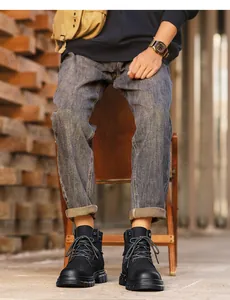 Detail view of rugged black leather work boots for men styled with casual denim jeans