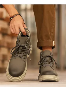 Close-up of olive green high-top Martin boots with rugged thick rubber soles for men's fashion