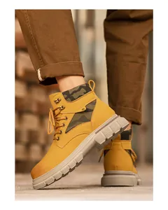 Detail of men's high-top work boots with camouflage patches and thick anti-slip sole
