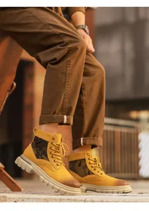 Detailed side view of men's mustard yellow camo high-top work boots with thick soles