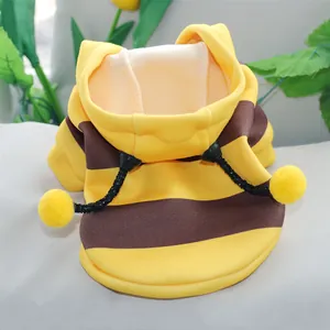 Detailed close-up of soft yellow and brown striped bee pet hoodie with pom-poms