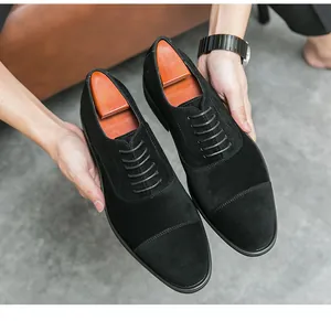 Macro detail of black suede cap-toe formal shoes featuring elegant wooden shoe trees