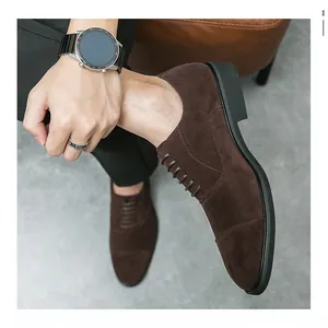 Close-up of dark brown suede cap-toe dress shoes worn with business attire
