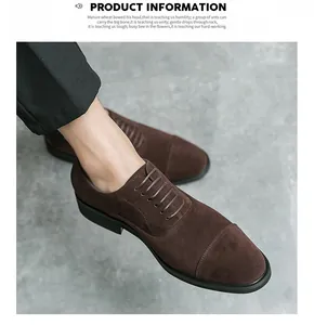 Close-up of brown suede cap-toe dress shoes worn with black trousers