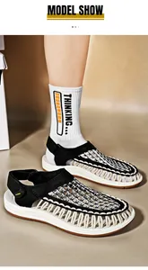 Close-up of black and white woven cord sandals for men featuring unique braided design