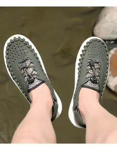 Detail view of army green men's woven sandals worn in an outdoor setting