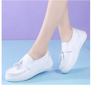 Detail view of white platform nurse shoes with tassels and soft breathable soles.