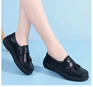 Detailed shot of comfortable black platform nurse shoes with decorative tassels