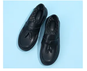 Detailed overhead view of black leather tassel loafers with breathable massage insoles