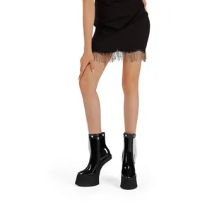 Elegant black patent leather platform boots featuring side zipper and bead fringe detail.
