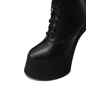 Close-up view of black platform lace-up ankle boots with premium leather texture detail