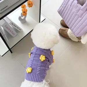 Warm purple knitted pet sweater with cute yellow flower decorations on a small white dog