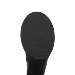 Macro view of the textured anti-slip rubber sole on women's black platform boots