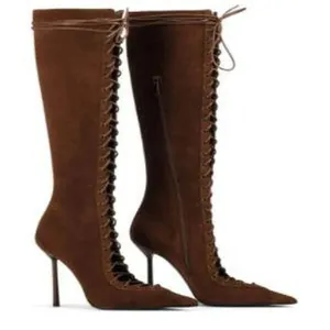 Detailed view of fashionable brown suede pointed toe stiletto lace-up knee-high boots