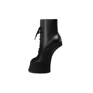 Macro view of black heelless platform ankle boots with lace-up design and matte finish