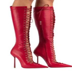 Detailed view of elegant red pointed-toe lace-up stiletto boots with hollow design