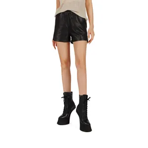 Detail view of black lace-up platform heelless ankle boots for women.