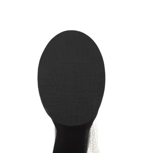 Detailed close-up of the non-slip rubber sole texture and pearl trim on women's platform boots