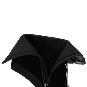 Detailed view of the side zipper and fabric lining on black patent leather boots.