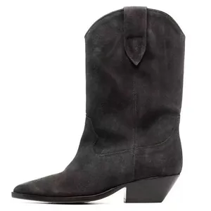 Detail view of a black suede western cowboy boot with pointed toe and chunky heel