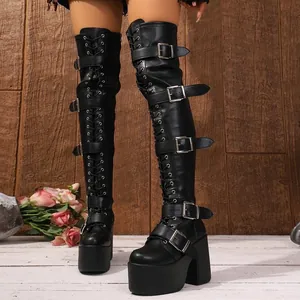 Detailed close-up of gothic punk black thigh-high platform boots with metal buckles
